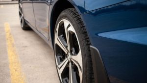 Close-up of a car wheel, showcasing the detailed design and tire tread, with a focus on the durability of sandblasting wheels.