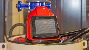 Red sandblasting helmet used for safety during wood sandblasting near me services.