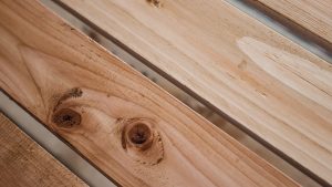 Close-up view of smooth wooden planks showing natural grain and knots after cleaning and refinishing, ideal example for wood sandblasting near me services.