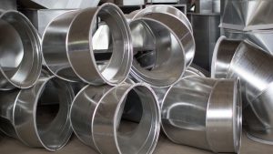 A stack of galvanized steel ductwork pieces, showcasing their shiny, smooth surfaces.