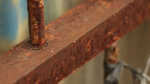 Close-up of rusted metal surface showing corrosion, highlighting whether sandblasted stainless steel will rust over time