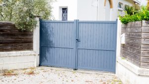 Steel gate restoration project prepared with sandblasting media for steel to remove rust, old paint, and surface contaminants before refinishing.